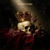 Hollow Crown gothic metal cover art – gold crowned human skull surrounded by dead red roses on crimson velvet dark background
